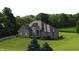 Beautiful single-Gathering home with a spacious yard, surrounded by lush greenery and mature trees at 8785 W 100 N, Anderson, IN 46011