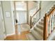 Inviting foyer with hardwood floors, elegant staircase, and ample natural light streaming through large windows at 8785 W 100 N, Anderson, IN 46011