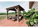 View of the property's spacious outdoor wooden gazebo with patio furniture and black & white outdoor rug at 8785 W 100 N, Anderson, IN 46011