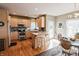 Kitchen with an island, wood cabinets, hardwood floors, and stainless steel appliances at 8785 W 100 N, Anderson, IN 46011