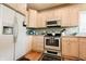 Traditional kitchen features stainless steel appliances, light cabinets, and hardwood floors at 8785 W 100 N, Anderson, IN 46011