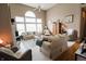 Bright living room with large windows, neutral furniture, and fireplace at 8785 W 100 N, Anderson, IN 46011