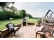 Spacious outdoor patio featuring outdoor furniture, a grill, and stone block border with lush greenery at 8785 W 100 N, Anderson, IN 46011