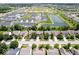 Overhead shot revealing a well-organized neighborhood with green spaces, a pond, and diverse housing options in a planned community at 8877 N White Tail Trl, McCordsville, IN 46055