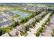Panoramic aerial view highlighting the neighborhood's layout, featuring homes, green spaces, and a scenic pond at 8877 N White Tail Trl, McCordsville, IN 46055