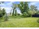 Expansive backyard featuring a mix of mature trees, shrubs, and a meticulously maintained lawn in a serene setting at 8877 N White Tail Trl, McCordsville, IN 46055