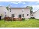 Backyard view showcasing a deck, lush lawn, and sliding glass doors to the home at 8877 N White Tail Trl, McCordsville, IN 46055