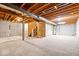 Unfinished basement with exposed wood beams and concrete walls ready for customization at 8877 N White Tail Trl, McCordsville, IN 46055
