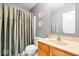 Cozy bathroom showcasing a wood vanity, neutral walls and a shower with stylish curtain at 8877 N White Tail Trl, McCordsville, IN 46055