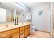 Well-lit bathroom featuring a double vanity, tile floors, and a framed mirror at 8877 N White Tail Trl, McCordsville, IN 46055