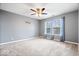 This bedroom features carpet, a modern ceiling fan, and two windows with natural light at 8877 N White Tail Trl, McCordsville, IN 46055