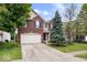 Charming two-story brick home with a well-maintained lawn and mature trees at 8877 N White Tail Trl, McCordsville, IN 46055