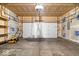 This garage features an open ceiling, a modern door, and plenty of open space at 8877 N White Tail Trl, McCordsville, IN 46055