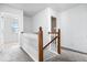 Bright hallway featuring carpet, white walls, and a staircase with wood accents at 8877 N White Tail Trl, McCordsville, IN 46055