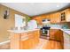 Kitchen with wood cabinets, stainless steel appliances and center island at 8877 N White Tail Trl, McCordsville, IN 46055