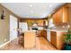 Eat-in kitchen with wood cabinets, a center island, and modern appliances at 8877 N White Tail Trl, McCordsville, IN 46055