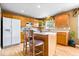 Eat-in kitchen features wood cabinets, a center island, and natural light at 8877 N White Tail Trl, McCordsville, IN 46055