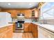Kitchen featuring wood cabinets, stainless steel appliances, and ample counter space at 8877 N White Tail Trl, McCordsville, IN 46055
