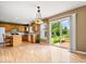 Eat-in kitchen featuring wood cabinets and sliding glass doors to the outdoor deck at 8877 N White Tail Trl, McCordsville, IN 46055