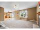 Open concept living room with a fireplace leading to kitchen and a sliding glass door at 8877 N White Tail Trl, McCordsville, IN 46055