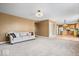 Open concept living room leading to kitchen with a sofa and neutral carpeting at 8877 N White Tail Trl, McCordsville, IN 46055