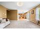 Open concept living room leading to kitchen with a sofa and neutral carpeting at 8877 N White Tail Trl, McCordsville, IN 46055