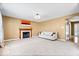 Spacious living room with a fireplace, large window, and neutral carpeting at 8877 N White Tail Trl, McCordsville, IN 46055