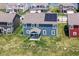 Aerial view of the back of a blue home with solar panels, a covered patio and a large yard at 9053 Fitzgerald Dr, Indianapolis, IN 46239