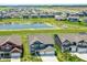 Expansive aerial view showcasing a neighborhood with a pond, green spaces, and neatly arranged homes at 9053 Fitzgerald Dr, Indianapolis, IN 46239