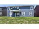 The backyard has a covered patio and view of the house's exterior vinyl siding at 9053 Fitzgerald Dr, Indianapolis, IN 46239