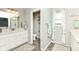 Bright bathroom with dual vanity, a toilet room and a window at 9053 Fitzgerald Dr, Indianapolis, IN 46239