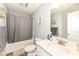 This bathroom features a shower/tub combo with grey shower curtain and a white vanity at 9053 Fitzgerald Dr, Indianapolis, IN 46239