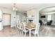 Bright dining room with a large table, seating for eight, and an open layout to the living spaces at 9053 Fitzgerald Dr, Indianapolis, IN 46239
