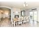 Dining room featuring an elegant table setting, fireplace, and ample natural light at 9053 Fitzgerald Dr, Indianapolis, IN 46239