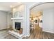 Elegant fireplace with stone surround, decorative mantle, and an open view to the dining area at 9053 Fitzgerald Dr, Indianapolis, IN 46239