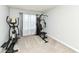 This workout room features carpeted floors and a full set of home gym equipment at 9053 Fitzgerald Dr, Indianapolis, IN 46239