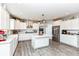 An open kitchen with stainless steel appliances, an island, and white cabinets offers a spacious cooking area at 9053 Fitzgerald Dr, Indianapolis, IN 46239