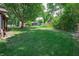 Large, open backyard with a lush green lawn and mature trees, offering privacy and space for recreation at 919 Dreamy St, Greenwood, IN 46142