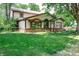 Rear exterior view showcasing architectural details, a well-maintained lawn, and mature landscaping at 919 Dreamy St, Greenwood, IN 46142