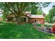The home's backyard showcases a fire pit area, green lawn, and mature trees for shade and privacy at 919 Dreamy St, Greenwood, IN 46142