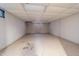 Unfinished basement with white walls, drop ceiling and window at 919 Dreamy St, Greenwood, IN 46142