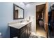 Charming bathroom with dark wood vanity, quartz countertop, framed mirror, and blue walls at 919 Dreamy St, Greenwood, IN 46142