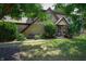 Charming two-story home featuring stone accents, a well-manicured lawn, and inviting front porch with seating at 919 Dreamy St, Greenwood, IN 46142