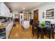 Bright kitchen with white cabinets, central island, and dark wood table, offering a spacious area for cooking and dining at 919 Dreamy St, Greenwood, IN 46142
