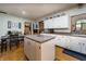 Inviting kitchen with a center island, white cabinetry, and adjacent dining space, great for Gathering gatherings at 919 Dreamy St, Greenwood, IN 46142