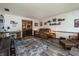 Inviting living room with a plush brown sofa, blue patterned rug, and views to the dining room at 919 Dreamy St, Greenwood, IN 46142
