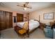 Warm main bedroom featuring a four poster bed, ceiling fan, and warm natural lighting at 919 Dreamy St, Greenwood, IN 46142