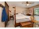 Warm main bedroom with a four-poster bed, ceiling fan, and soft natural lighting at 919 Dreamy St, Greenwood, IN 46142