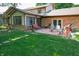 Home's backyard with a patio, seating, and ample green space for outdoor activities, featuring lush lawn at 919 Dreamy St, Greenwood, IN 46142