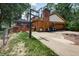 Back exterior featuring a brick chimney, basketball hoop, garage, and a fenced backyard with a wooden deck at 919 Dreamy St, Greenwood, IN 46142